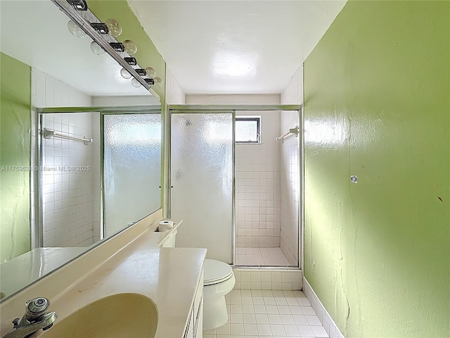 full bathroom with tile patterned floors, a shower stall, vanity, and toilet