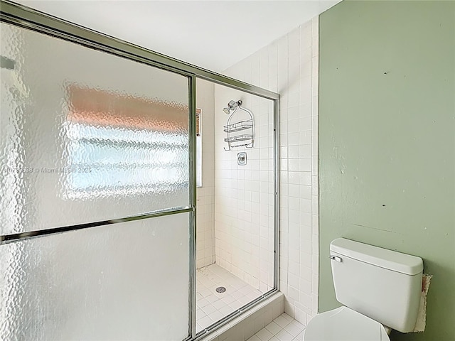 full bathroom featuring toilet and a stall shower