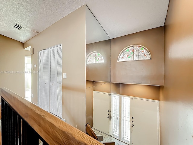 foyer with visible vents, plenty of natural light, and a textured ceiling