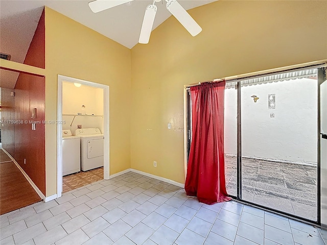 spare room featuring washer and clothes dryer, baseboards, high vaulted ceiling, and ceiling fan