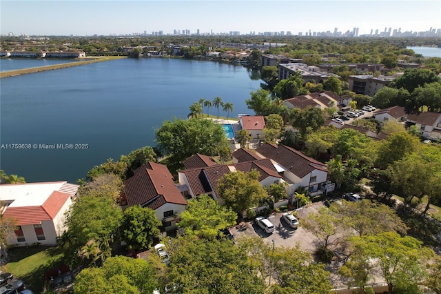 birds eye view of property with a water view and a city view