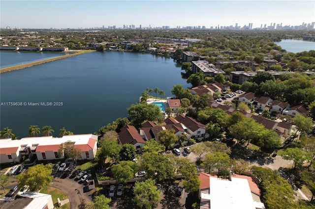 birds eye view of property with a water view and a city view