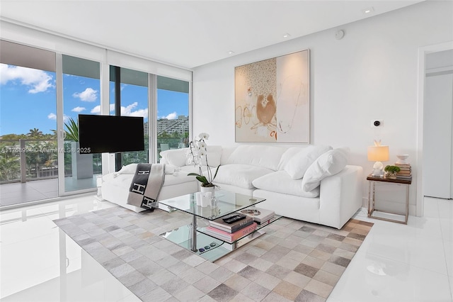 living area with tile patterned floors and floor to ceiling windows