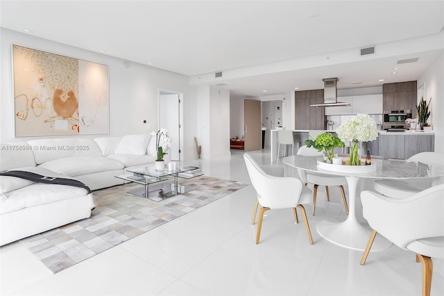 living area featuring tile patterned floors and visible vents