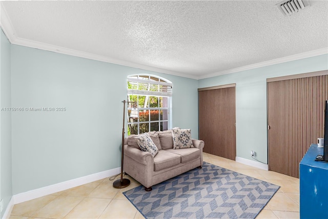 living area with light tile patterned floors, crown molding, baseboards, and a textured ceiling