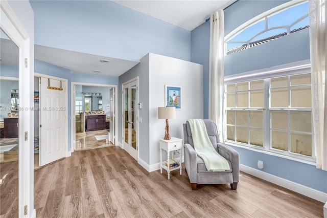 sitting room featuring baseboards and wood finished floors