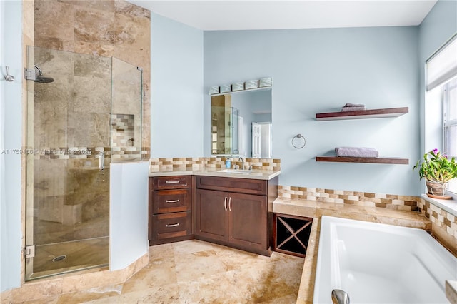 full bathroom with a stall shower, a bathing tub, vanity, and backsplash