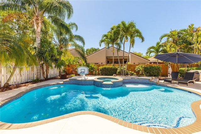 view of pool with a patio area, a fenced backyard, and a pool with connected hot tub