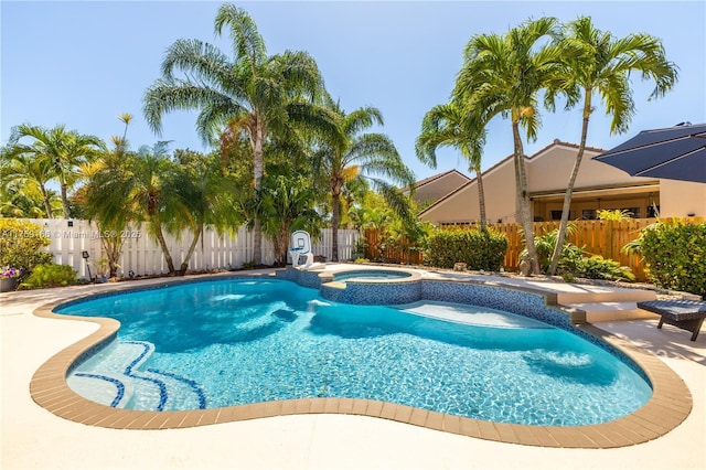 view of pool with a patio area, a fenced backyard, and a pool with connected hot tub