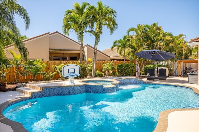 view of pool with a fenced in pool, an in ground hot tub, fence, a water slide, and a patio area