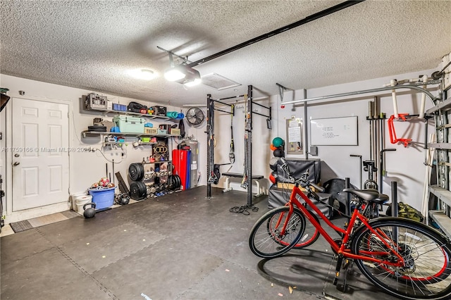 garage with a garage door opener and electric water heater