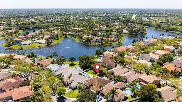 drone / aerial view featuring a water view and a residential view