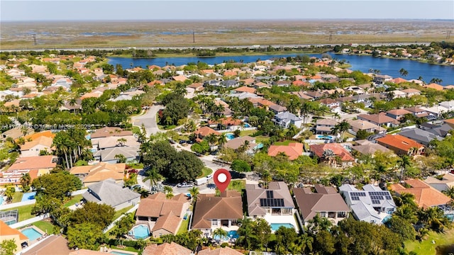 bird's eye view with a water view and a residential view