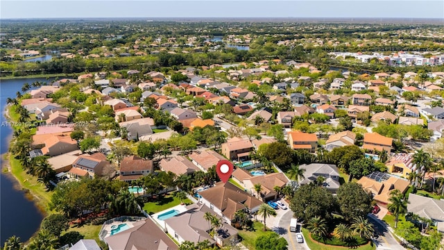 birds eye view of property with a residential view and a water view