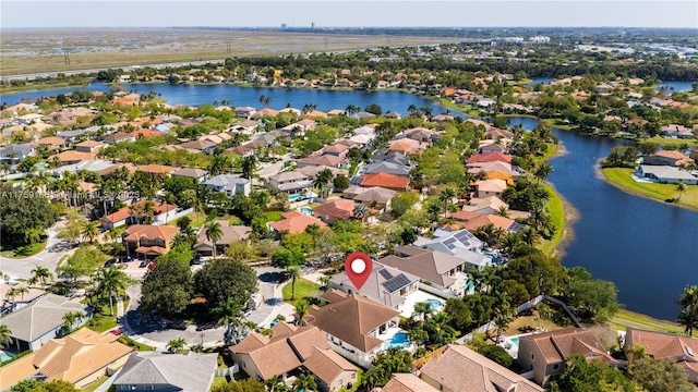 birds eye view of property with a water view and a residential view