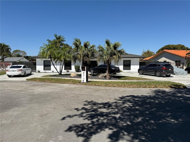 view of front of property featuring fence and stucco siding