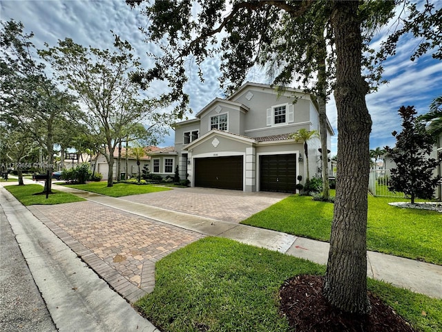 view of front of house with a garage, a front lawn, decorative driveway, and stucco siding