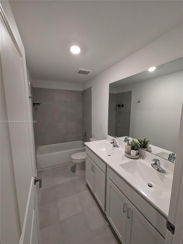 bathroom with visible vents, a sink, toilet, and tub / shower combination