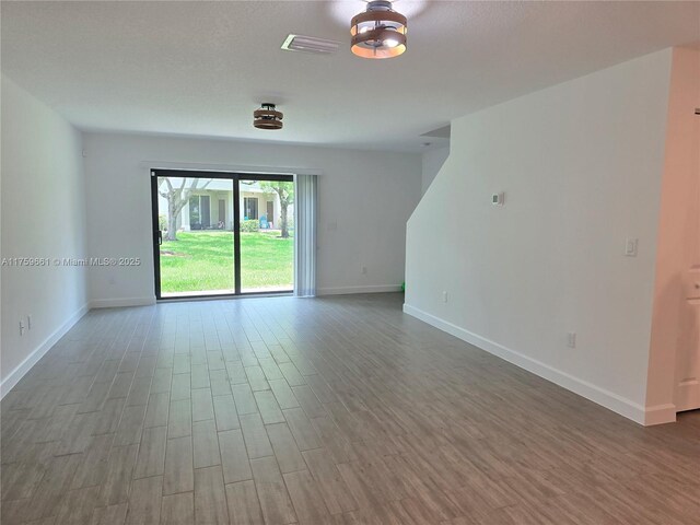 6001 Woods Edge Cir, Riviera Beach, FL 33410 - spare room with wood finished floors and baseboards
