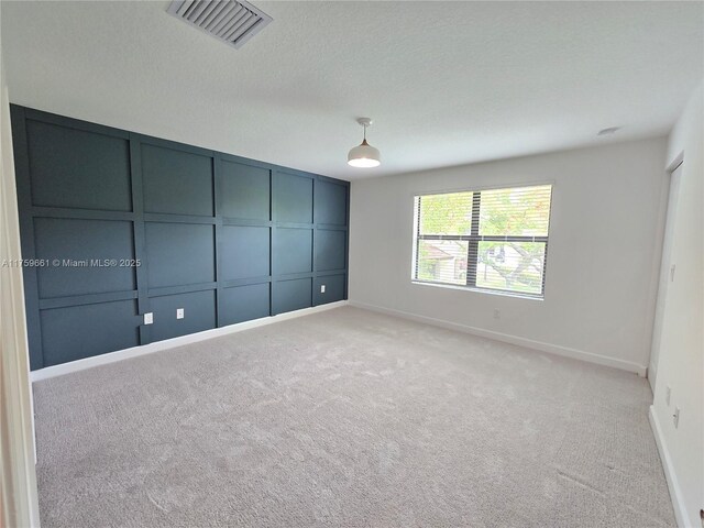 6001 Woods Edge Cir, Riviera Beach, FL 33410 - spare room featuring light colored carpet and baseboards