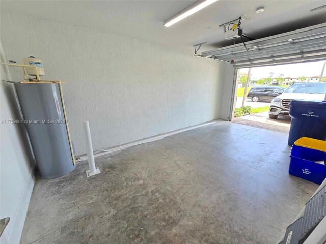 6001 Woods Edge Cir, Riviera Beach, FL 33410 - garage with a garage door opener and water heater