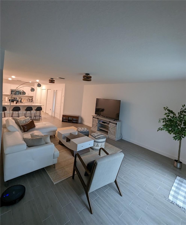 living room with wood finish floors and baseboards