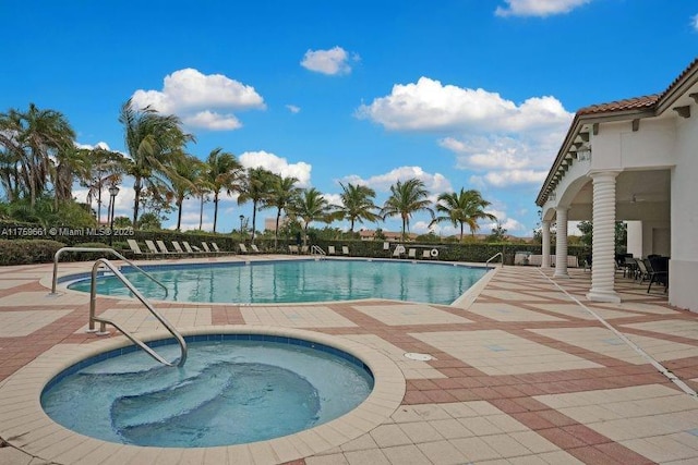 community pool with a community hot tub and a patio