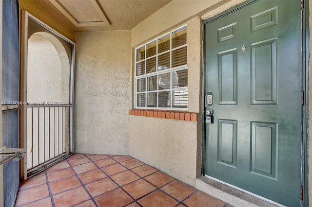 entrance to property featuring stucco siding