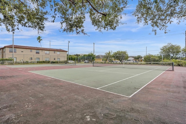 view of sport court featuring fence