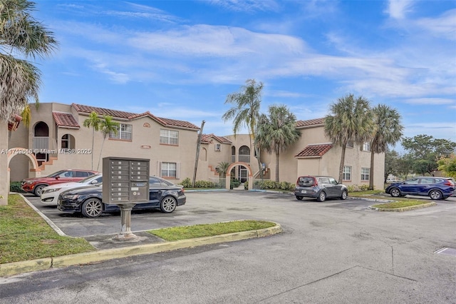 view of property featuring uncovered parking and a residential view