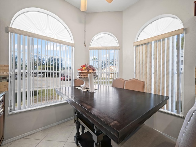 dining room featuring light tile patterned floors, baseboards, and a ceiling fan