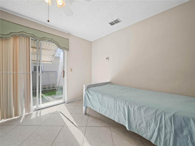 bedroom featuring access to exterior, visible vents, multiple windows, and light tile patterned floors