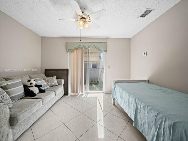 bedroom with light tile patterned floors, visible vents, a ceiling fan, access to exterior, and a textured ceiling