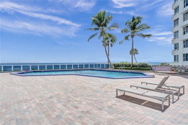 community pool with a patio area