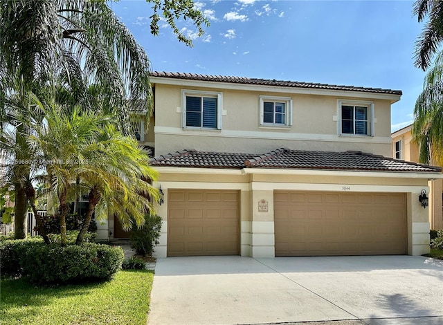 view of front of home with stucco siding, concrete driveway, an attached garage, and a tile roof