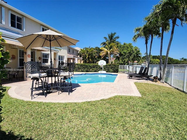 view of swimming pool featuring a fenced in pool, a patio, a lawn, and fence