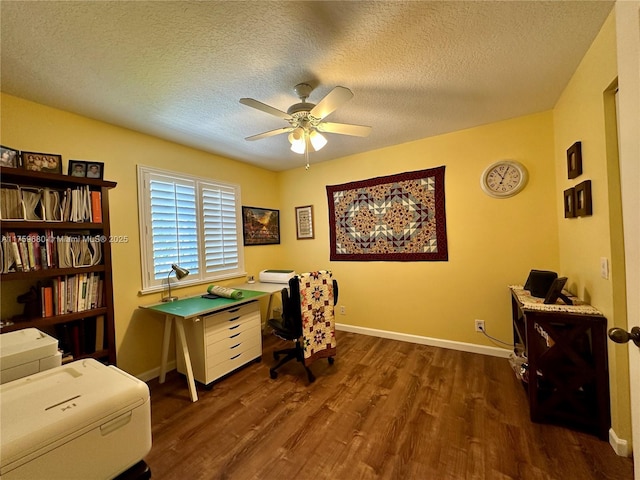 office featuring baseboards, a textured ceiling, ceiling fan, and dark wood-style flooring