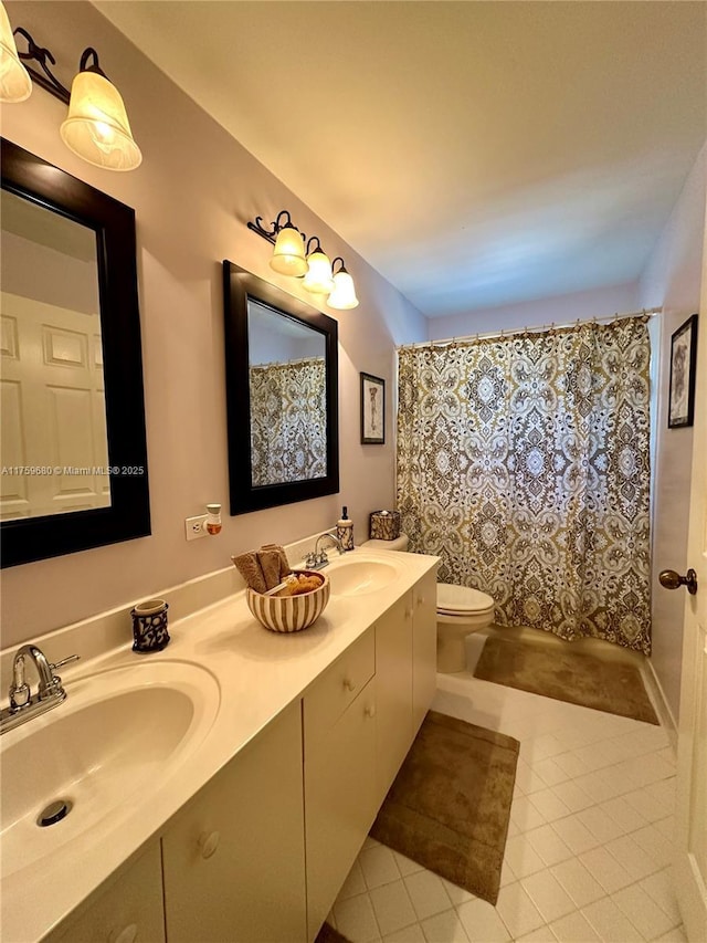 bathroom featuring tile patterned flooring, double vanity, toilet, and a sink