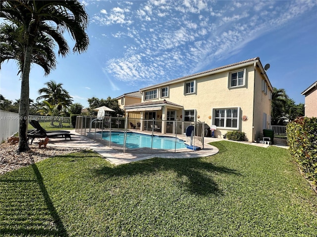 view of swimming pool with a patio, a lawn, a fenced in pool, and a fenced backyard