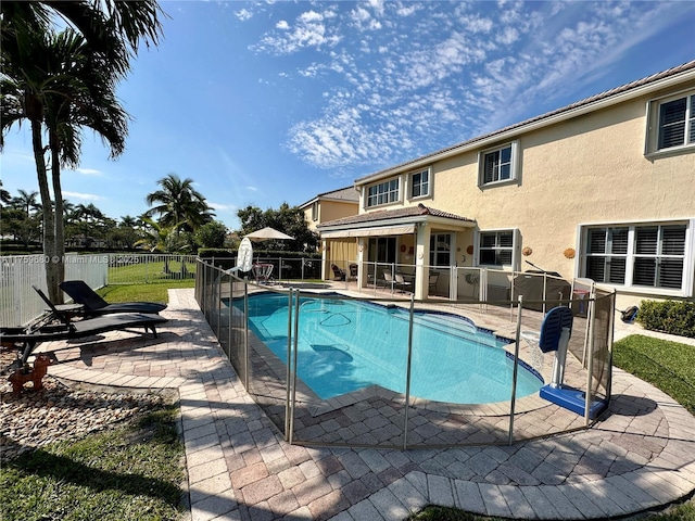 view of swimming pool featuring a fenced in pool, a patio, and fence