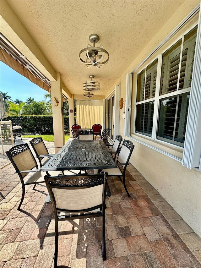 view of patio featuring outdoor dining space and a ceiling fan