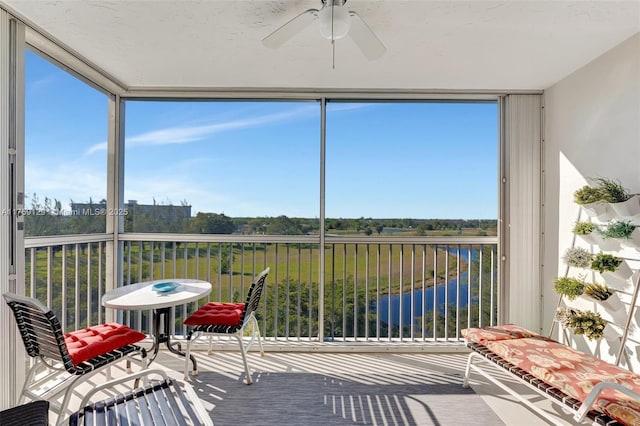 sunroom / solarium with ceiling fan and plenty of natural light