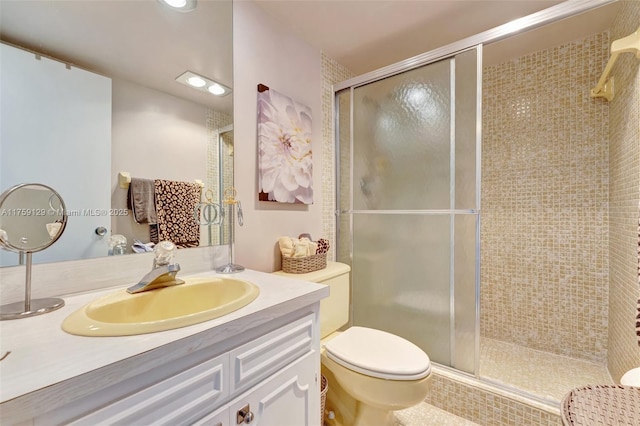 full bath with toilet, a stall shower, recessed lighting, and vanity