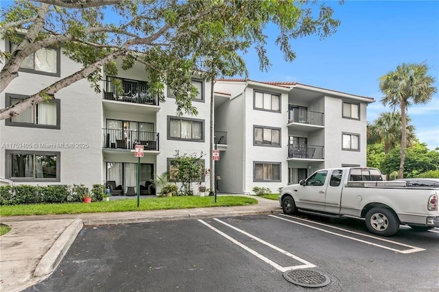 view of property featuring uncovered parking