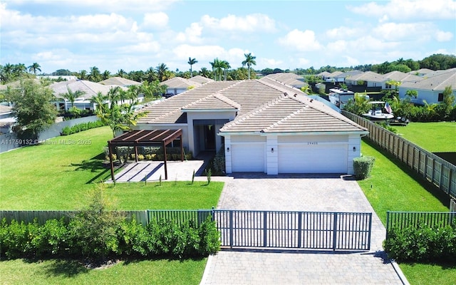 ranch-style house featuring a front yard, decorative driveway, and fence private yard