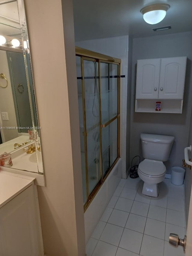 full bathroom featuring visible vents, toilet, enclosed tub / shower combo, vanity, and tile patterned floors