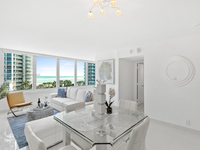 living room with a chandelier, tile patterned flooring, and a water view