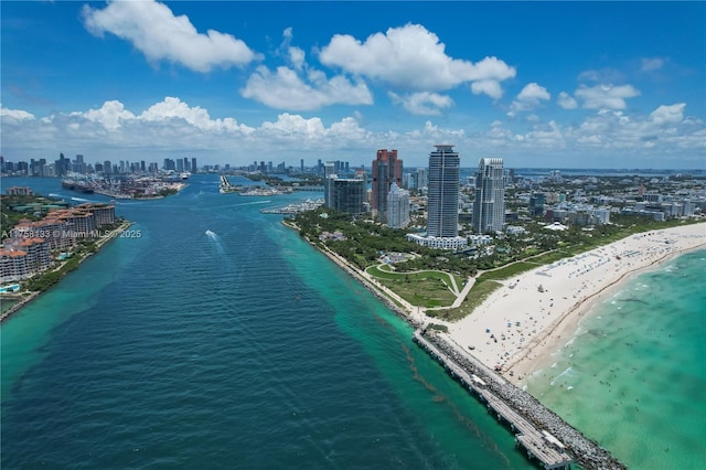 birds eye view of property with a city view, a water view, and a beach view