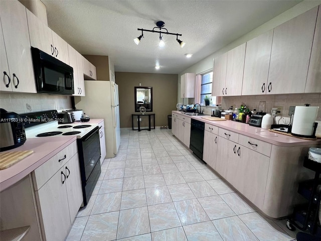 kitchen with tasteful backsplash, light countertops, and black appliances