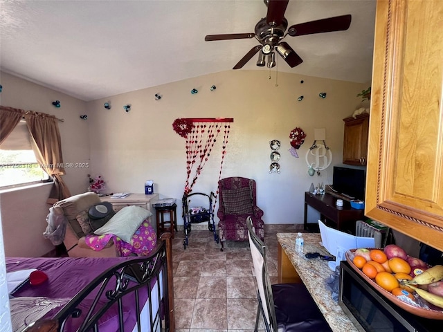 bedroom featuring lofted ceiling, ceiling fan, and light tile patterned floors